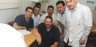 Nich Woolf (centre in black shirt) met the man, who is not pictured, while working in Afghanistan