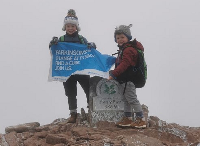 Two young brothers from Highbridge have climbed the highest peak in England and Wales to raise more than £1,500 for a charity close to their hearts.