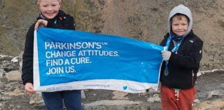Two young brothers from Highbridge have climbed the highest peak in England and Wales to raise more than £1,500 for a charity close to their hearts.