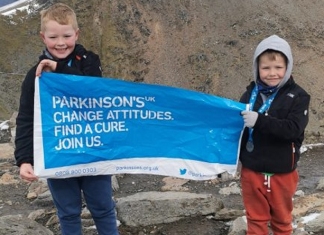 Two young brothers from Highbridge have climbed the highest peak in England and Wales to raise more than £1,500 for a charity close to their hearts.