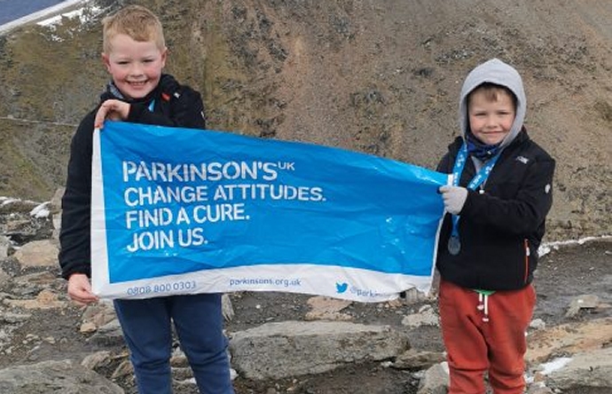 Two young brothers from Highbridge have climbed the highest peak in England and Wales to raise more than £1,500 for a charity close to their hearts.