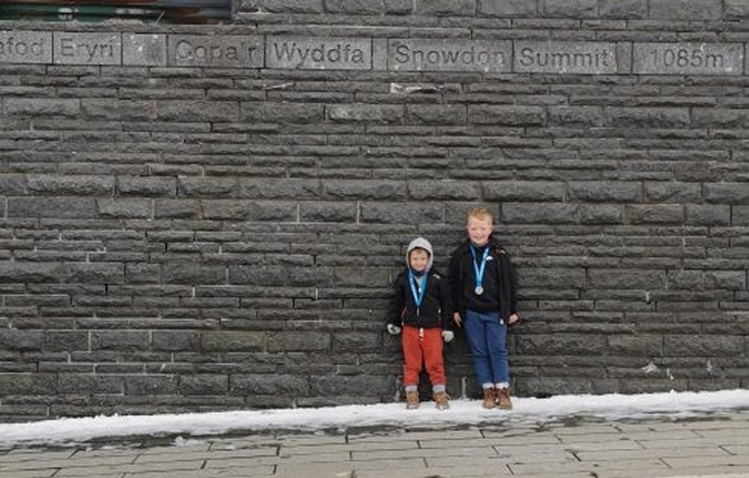 Two young brothers from Highbridge have climbed the highest peak in England and Wales to raise more than £1,500 for a charity close to their hearts.